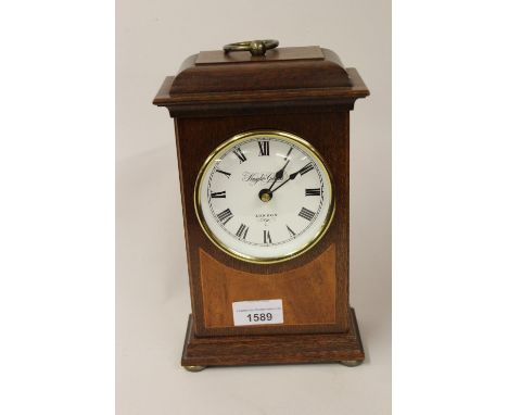 Reproduction mahogany and inlaid mantel clock, the dial inscribed Knight and Gibbins London, with a quartz movement 