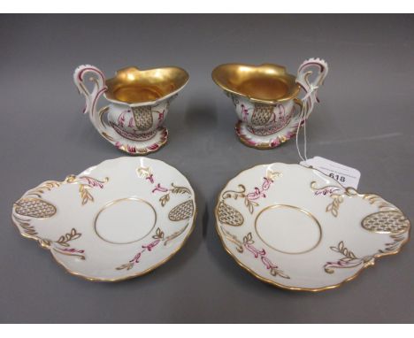 Pair of modern Dresden cabinet cups with saucers, the helmet shaped bowls with gilt interiors and scroll handlesThese are bot