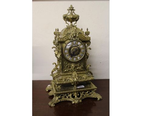 19th Century French ornate gilt brass mantel clock with urn surmount with enamel Roman numerals and inscribed Muirhead and So