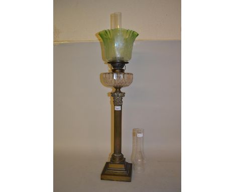 Edwardian brass Corinthian column oil lamp with green glass shade and two chimneysSome small chips to edges of oil well but n