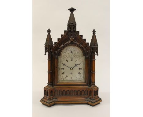 19th Century figured walnut bracket clock of Gothic Revival design, the architectural case with three spires above a broken a