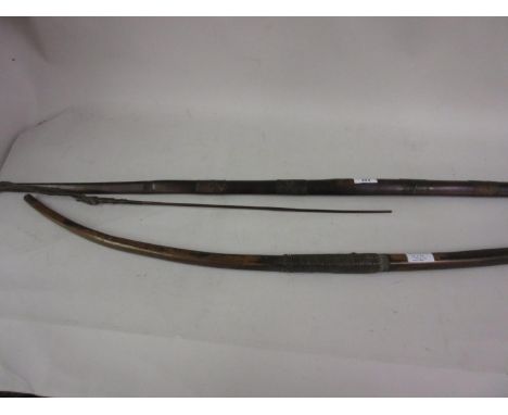 Wooden shafted leather bound Woomera stick and a wooden bow with leather wire twist grip 