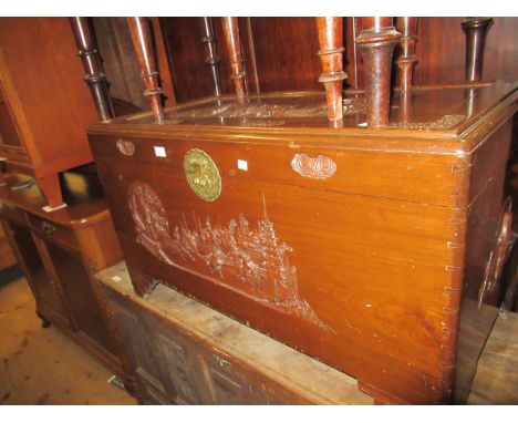 Oriental carved camphor wood trunk, the front panel relief carved with figures and landscape on bracket feet, 40ins wide 