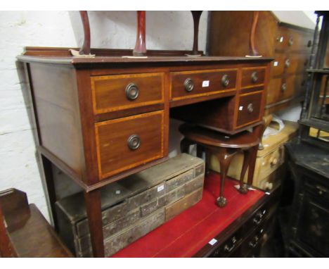 Edwardian mahogany kneehole desk having an arrangement of five drawers with ring handles raised on square tapering supports w