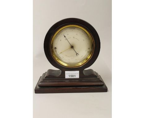 19th Century circular gilt brass cased aneroid barometer / thermometer with silvered dial, inscribed verso ' Sold by C.W. Dix