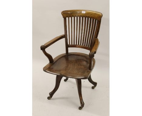 Late 19th  / early 20th Century mahogany slat back desk chair, having moulded arms with solid seat and four cabriole supports