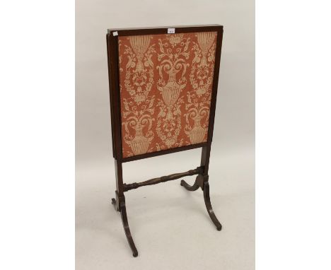 19th Century mahogany firescreen with sliding fabric covered panels on sabre legs 