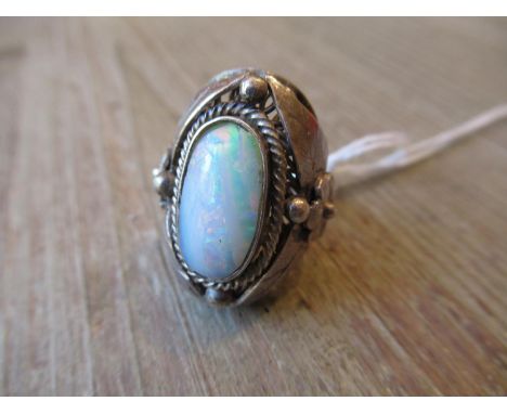 Silver and opal set dress ring of Arts and Crafts design, the setting in the form of flower heads and leavesSize P 