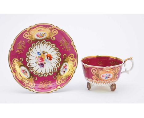 H&amp;R Daniel - A teacup and saucer, circa 1827pattern 4412, of 'C' scroll shape, the cup raised on three 'daisy wheel' feet