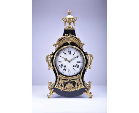 A 19th century Louis XV style ebonised bracket clock and bracketThe cartouche case surmounted by a brass urn finial and appli