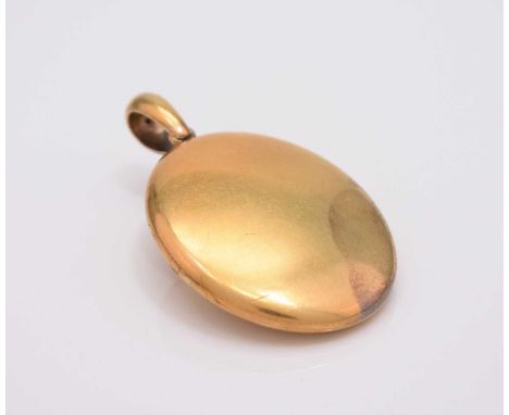 A late 19th century yellow metal locket, of plain polished oval form, 60mm x 36mm (including lug), weight approx 31.7g, prese