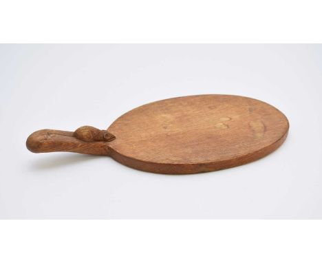 Workshop of Robert Mouseman Thompson (Kilburn): An English oak cheese boardCirca 1995, of standard oval form, with carved mou