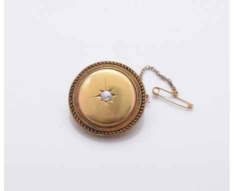 A late 19th century diamond set brooch, the central old cut diamond star set to circular mount with rope twist border, the en