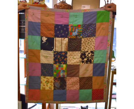 Quilt - A small quilt possibly for a baby's cot, a simple square patch design with a border bound from behind, the middle of 