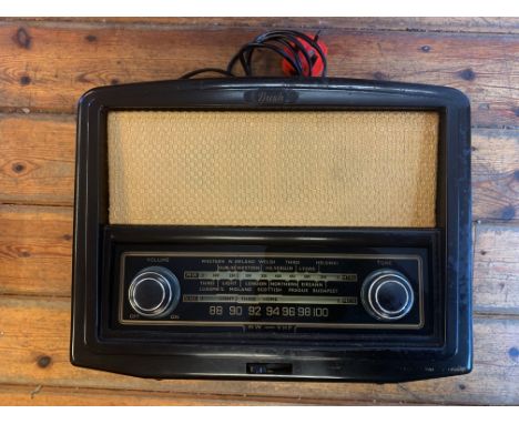 VINTAGE BAKELITE RADIO. A vintage Bush VHF90 valve radio receiver, circa 1956. Dark brown bakelite casing with front tuning p