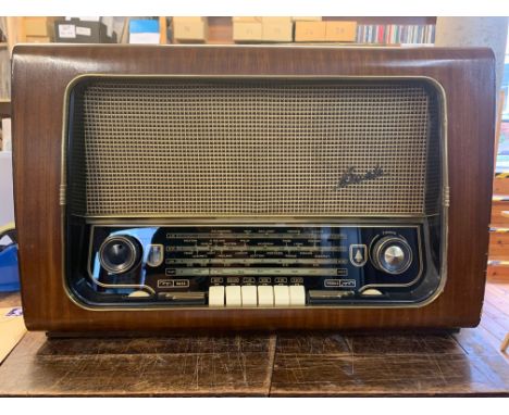 A Vintage Bush Radio Receiver. A vintage Bush VHF 64 AC mains four band AM/FM table radio housed in an attractive wooden Deco