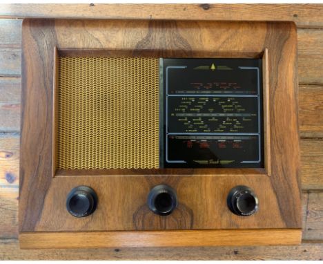 Vintage 1950s Valve Radio. A Bush A.C.31 Tabletop valve radio with wooden casing, metal speaker grille glass tuning plate and