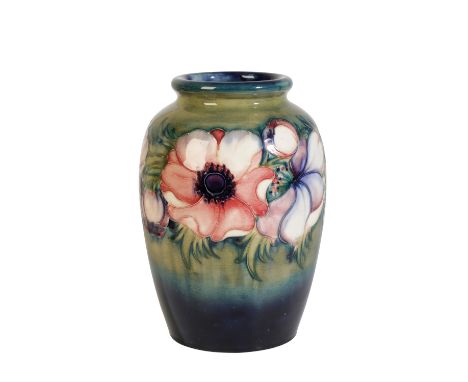 WILLIAM MOORCROFT: AN "ANEMONE" PATTERN VASE, oviform with everted rim, decorated with pink and purple flowers on a blue and 