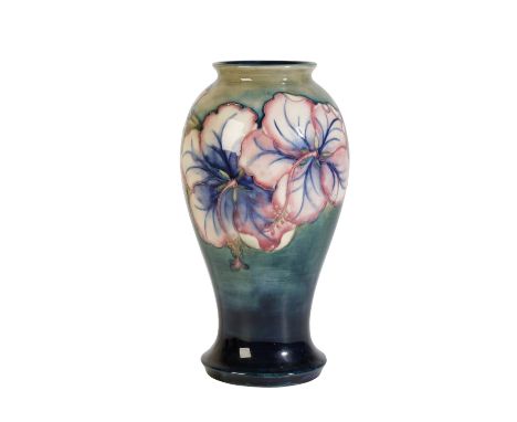 WILLIAM MOORCROFT: A "HIBISCUS" VASE, shouldered form, decorated with flowers on a blue and green ground, signed and impresse