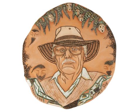 JOHN BENFIELD: A TERRACOTA PLAQUE, modelled as a portrait of Guy Sydenham, applied with five glazed monkey heads, signed mark