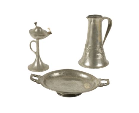 ARCHIBALD KNOX FOR LIBERTY & CO: A "TUDRIC" PEWTER HOT WATER JUG, tapering cylindrical form with scroll handle, the body deco