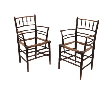 ATTRIB. MORRIS & CO: A PAIR OF EBONISED ASH "SUSSEX" ARMCHAIR FRAMES, probably designed by Phillip Webb, turned bobbin back a