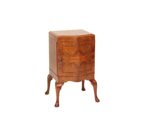 MAURICE ADAMS: A WALNUT POT CUPBOARD, the serpentine front with single door, raised on four cabriole legs, plaque to reverse,