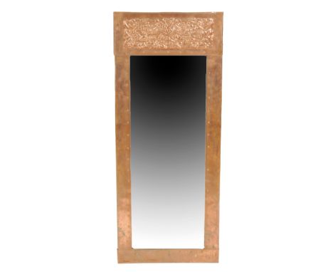 IN THE MANNER OF KESWICK SCHOOL: AN ARTS AND CRAFTS COPPER FRAMED MIRROR, rectangular form, central bevelled mirror plate, th