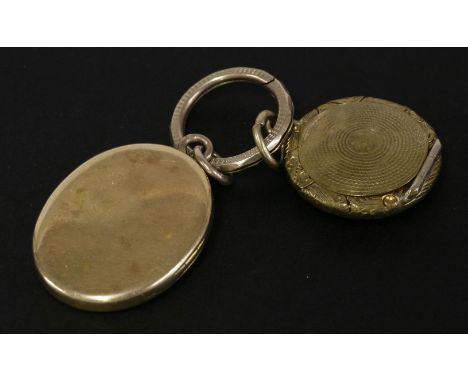 A Victorian gold oval locket, with engraved inscription, tested as approximately 18ct, and a gilt metal chased locket, both s