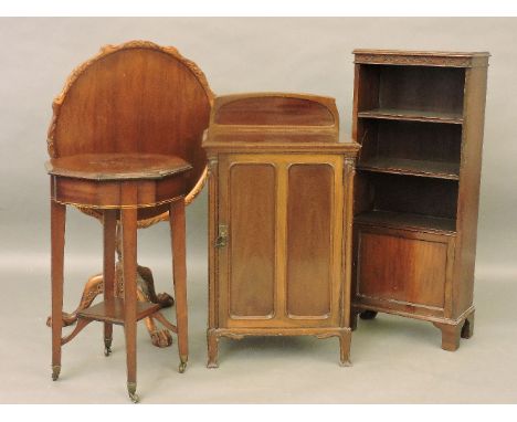 An Art Nouveau mahogany cabinet, 52cm wide, an octagonal table, 45cm diameter, a narrow book case, and tripod table, 68cm dia