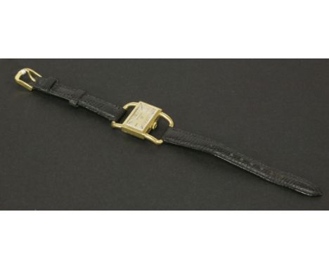 A ladies 18ct gold Jaeger Lecoultre mechanical strap watch, c.1960. Also known as the 'saddle model', rectangular portrait ca