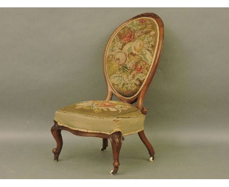 A Victorian walnut nursing chair, with tapestry upholstery
