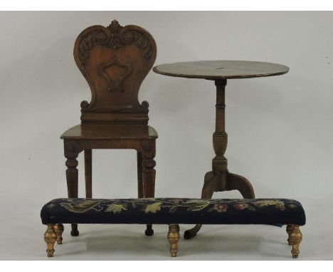 A Victorian oak shield back hall chair, 42cm wide, with a 19th century oak tripod table, 54cm diameter and a long low footsto