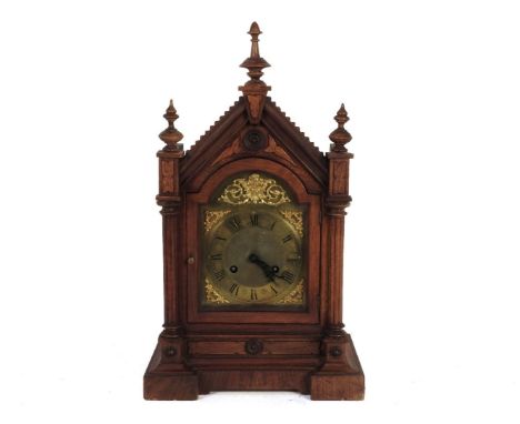 A walnut carved architectural mantel clock, with arched dial, 49.5cm high