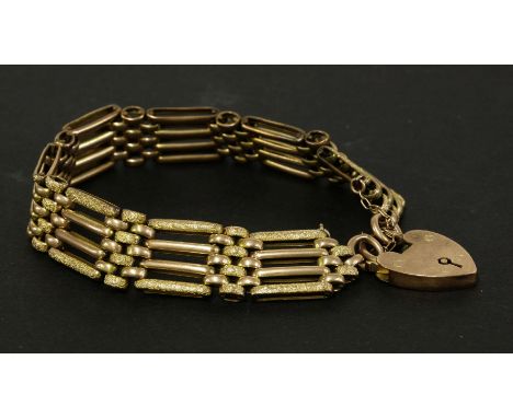 A gold four bar gate textured chased decorated link bracelet, marked 9ct, with 9ct gold padlock, 22.74g