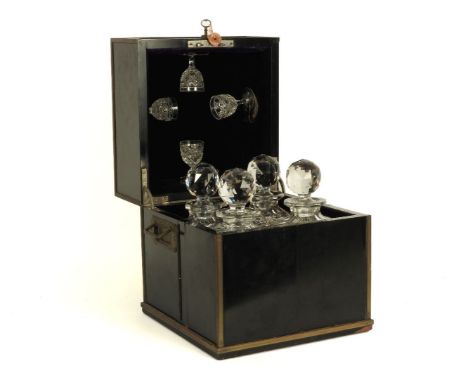 A late 19th century cased decanter set, retailed by J. C. Rait of Glasgow, the ebonised case with brass fittings and a Bramah
