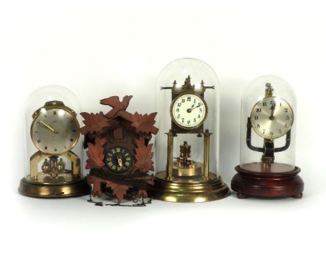 Three anniversary clocks, and a cuckoo clock with weights, 30cm high