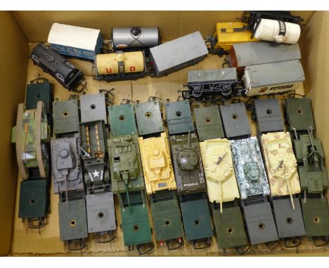 Ten model tanks on Tri-ang model rail transporters and a collection of wagons 