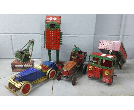 Five Meccano models; tipper truck, tow vehicles, a robot and crane 
