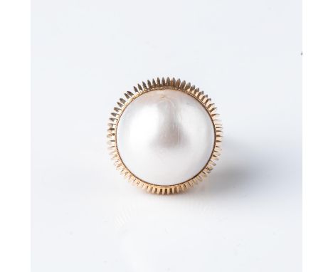 Bezel-set to the centre with a 15mm round mabÃ© pearl in an 18ct yellow gold ring with a detailed wire curved setting, size K