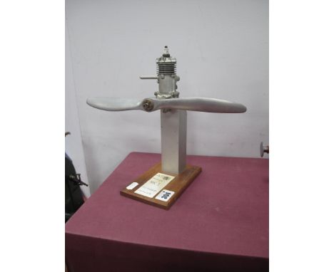An Atom Minor MKI Model Aero Engine, exhaust, liquid fuelled, mounted on a wooden 'Test bed', board, propeller span 29cm