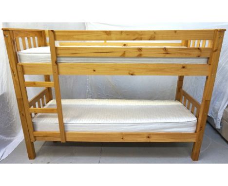 CHILD'S PINE BUNK BEDwith slatted ends, integral ladder and two new mattresses, 198cm wide  