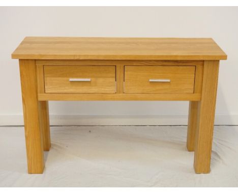 LIGHT OAK SIDE TABLEwith an oblong top above two frieze drawers, standing on block supports, 120cm wide 