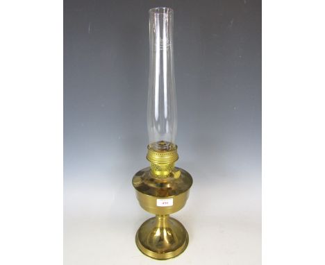 A brass oil lamp and boxed wicks