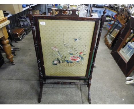A Victorian mahogany embroidered fire screen, depicting birds and blossom 