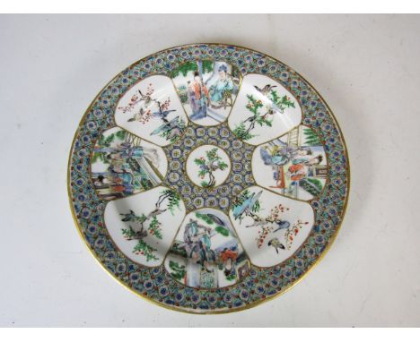 A late Victorian Royal Worcester Chinoiserie plate, hand enamelled with figures and birds, reserved over a densely patterned 