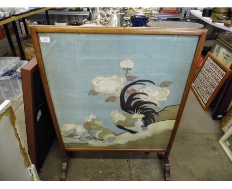 An early 20th Century mahogany fire screen with wooden panel 