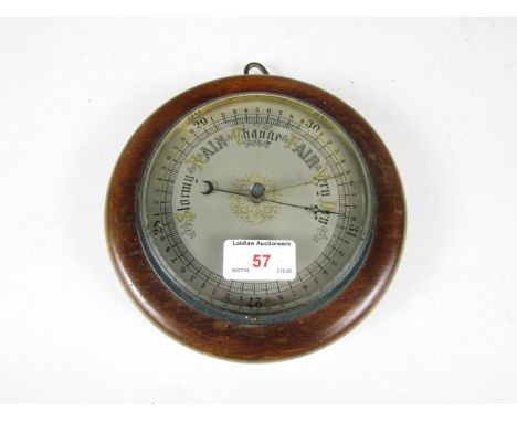 A Victorian carved oak circular barometer 