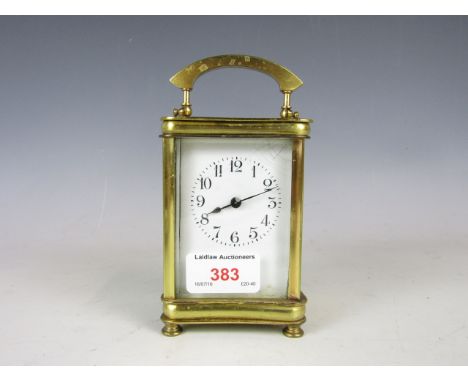 A brass carriage clock and key