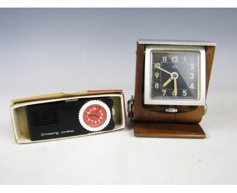 A mid 20th Century UTI travel alarm clock in a folding wooden case, together with a Blessing Miniboy 